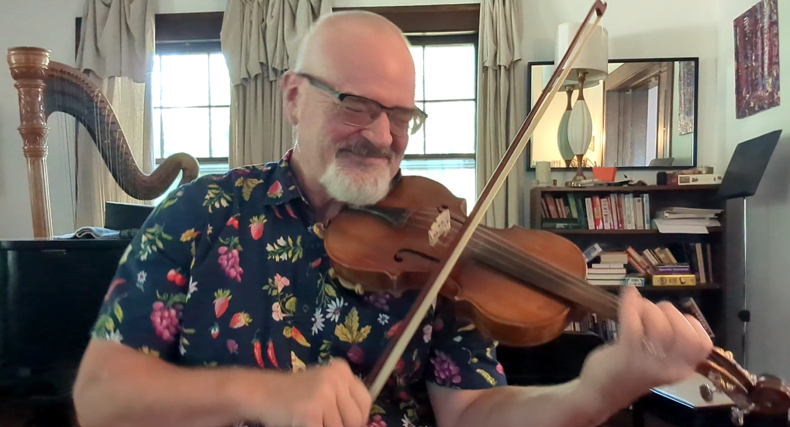 Screenshot 2025-10-16 184318 Man, seated, playing a fiddle and smiling at camera